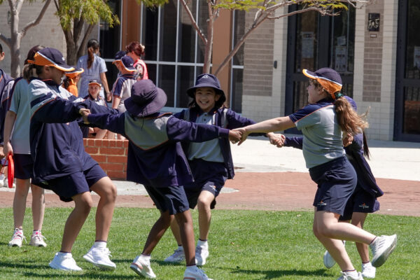 Students playing on the grass at Holy Cross College